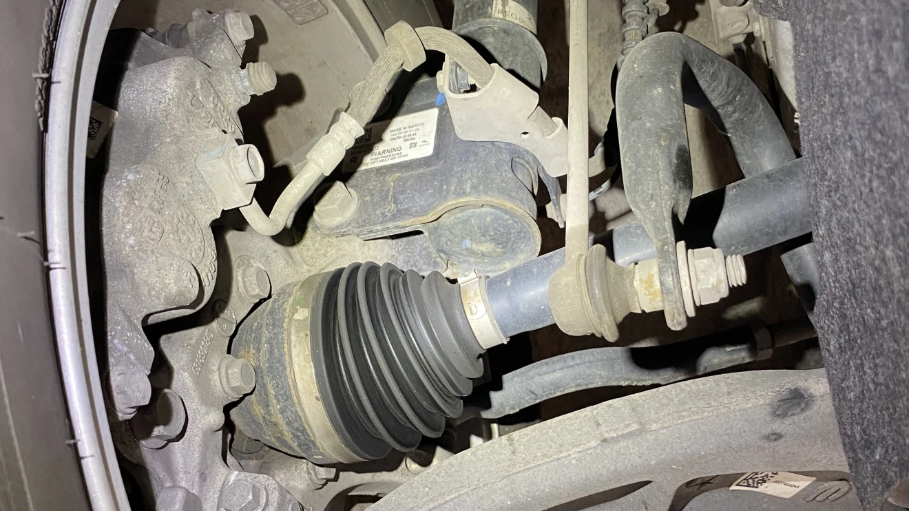 Technician inspecting suspension components