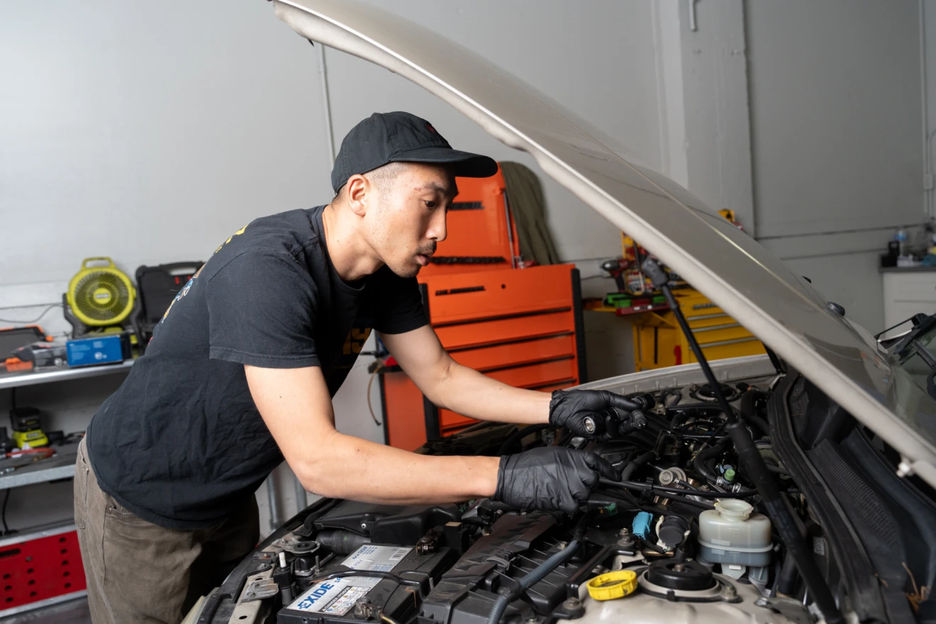 Technician working in engine compartment