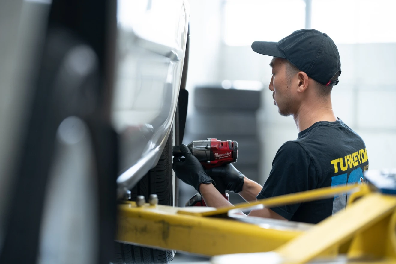 Technician installing wheel